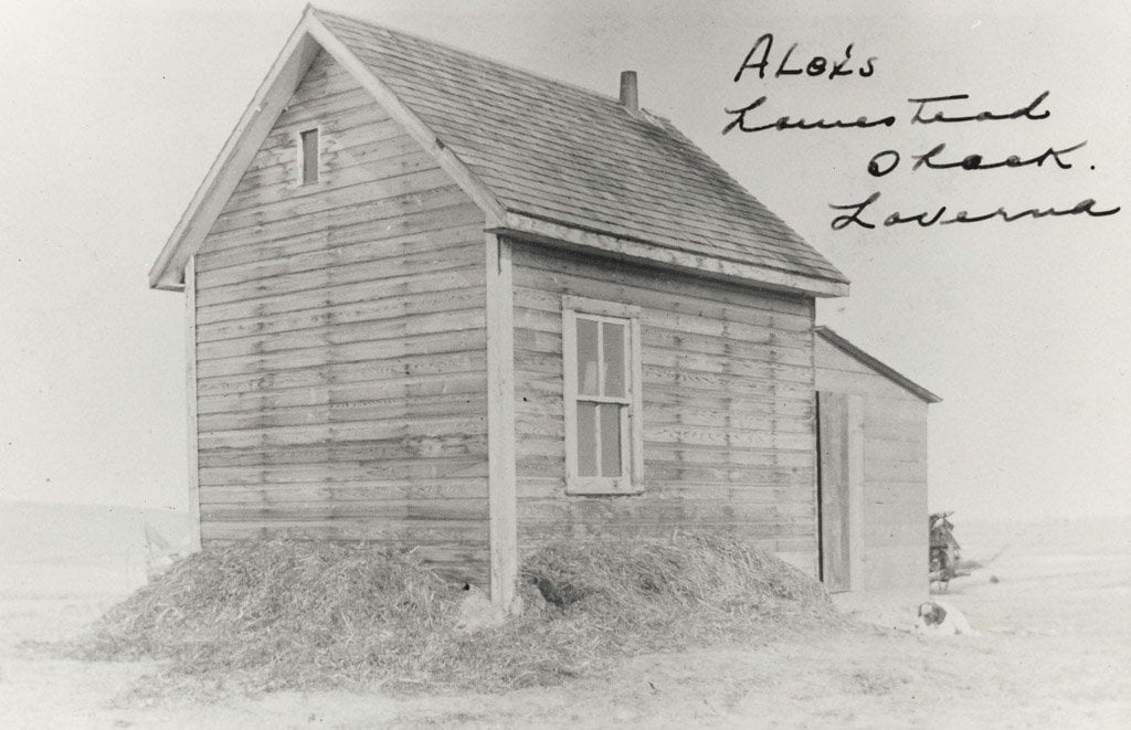 Black and white photo of wooden farm house