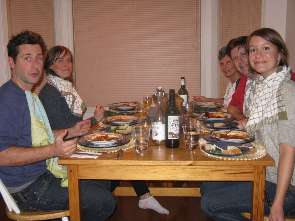 Family around a dining room table eating Cioppino